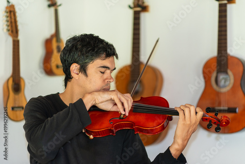 Man playing violin in home studio