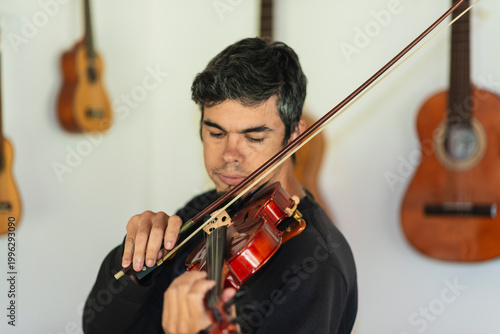 Man playing violin in home studio