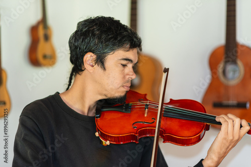 Man playing violin in home studio