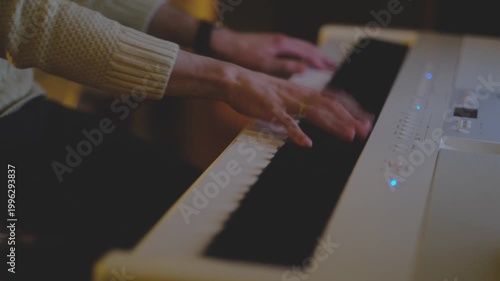 Fast moving hands playing white digital piano in warm cinematic light, energetic music performance, close up keyboard scene with dynamic motion indoors.