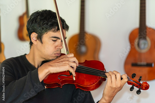 Man playing violin in home studio
