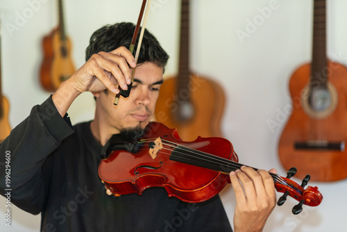 Man playing violin in home studio