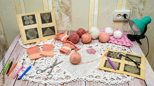 handicraft still life with knitting threads tools and vintage books on the table