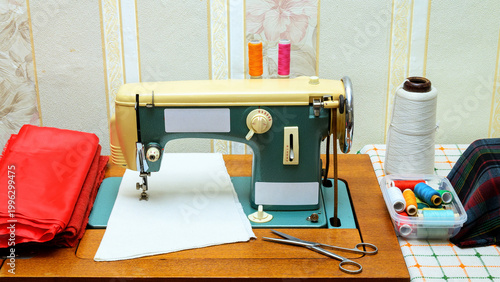 vintage green sewing machine on a table with threads