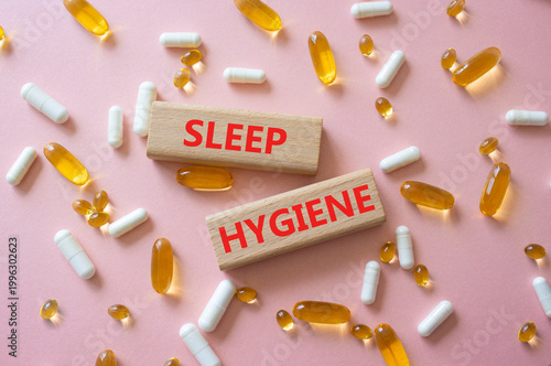 SLEEP HYGIENE symbol. Concept word SLEEP HYGIENE on wooden blocks. Beautiful pink background with pills. Medicine and SLEEP HYGIENE. Copy space