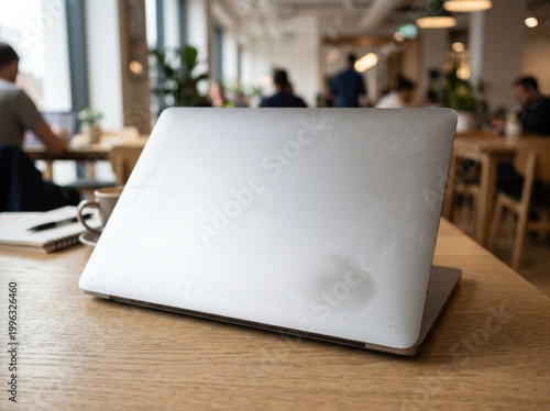 Closed Blank Silver Laptop Cover on Wooden Desk for Technology and Sticker Mockups