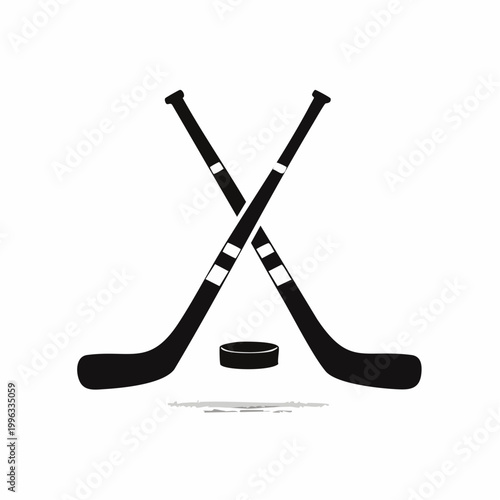 Two hockey sticks crossed over puck on ice rink surface