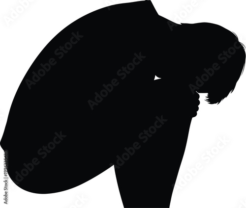 Silhouette of a person kneeling in a dark and mysterious setting