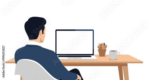 A man sitting at a wooden desk working on a blank screen computer monitor.
