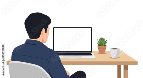 A man sitting at a desk working on a blank screen laptop.