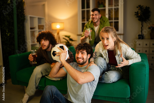 Fotografi Friends cheering excitedly watching soccer match home