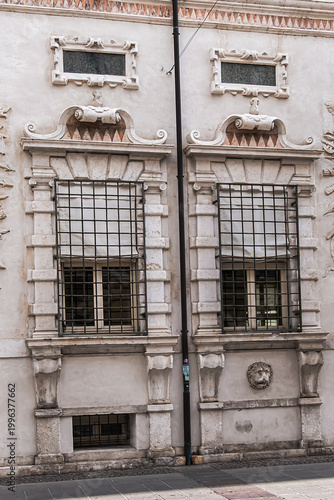 Late-Renaissance palace Bentivoglio (from 1449) is located on Via Garibaldi. Bentivoglio decorated the facade with military trophy symbols in marble. Ferrara, Region of Emilia-Romagna, Italy.