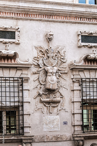 Late-Renaissance palace Bentivoglio (from 1449) is located on Via Garibaldi. Bentivoglio decorated the facade with military trophy symbols in marble. Ferrara, Region of Emilia-Romagna, Italy.