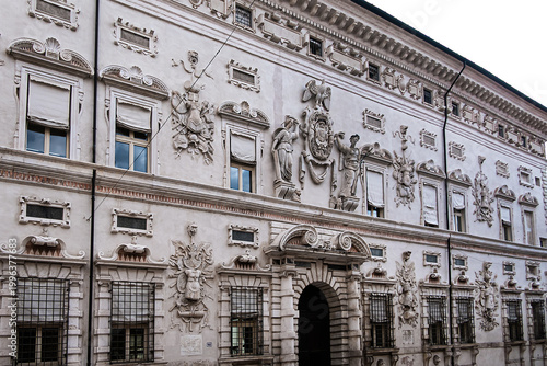 Late-Renaissance palace Bentivoglio (from 1449) is located on Via Garibaldi. Bentivoglio decorated the facade with military trophy symbols in marble. Ferrara, Region of Emilia-Romagna, Italy.