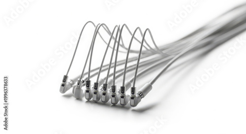 A series of delicate white dental implant connectors, artfully arranged in a sweeping curve on a clean white background, symbolizing dental restoration.
