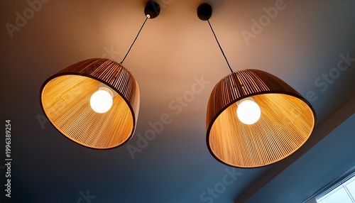 pair of modern wooden pendant lights illuminating a room