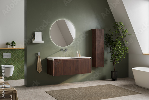 Photos Modern bathroom interior with olive green wall, round mirror, floating wood vanity, freestanding bathtub, and soft natural light