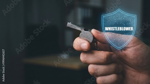 Hand Gripping a Metallic Whistle with Digital Shield for Legal Protection Concept