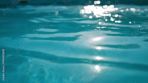 Sunlight Reflecting on Rippling Blue Swimming Pool Water