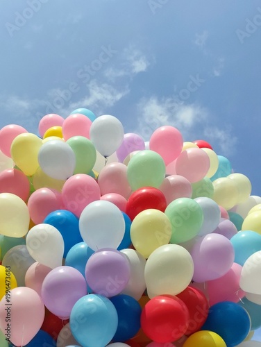 Many colorful balloons floating in sky, celebration and festive background.
