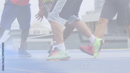 Men dribbling ball on blue sports court, neon shoes drawing defenders, blue flare marking footwork
