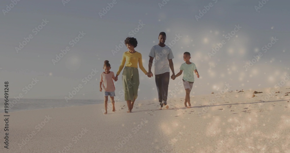 Obraz premium Walking family of four holding hands along shore near ocean, leaving footprints in bright clothes