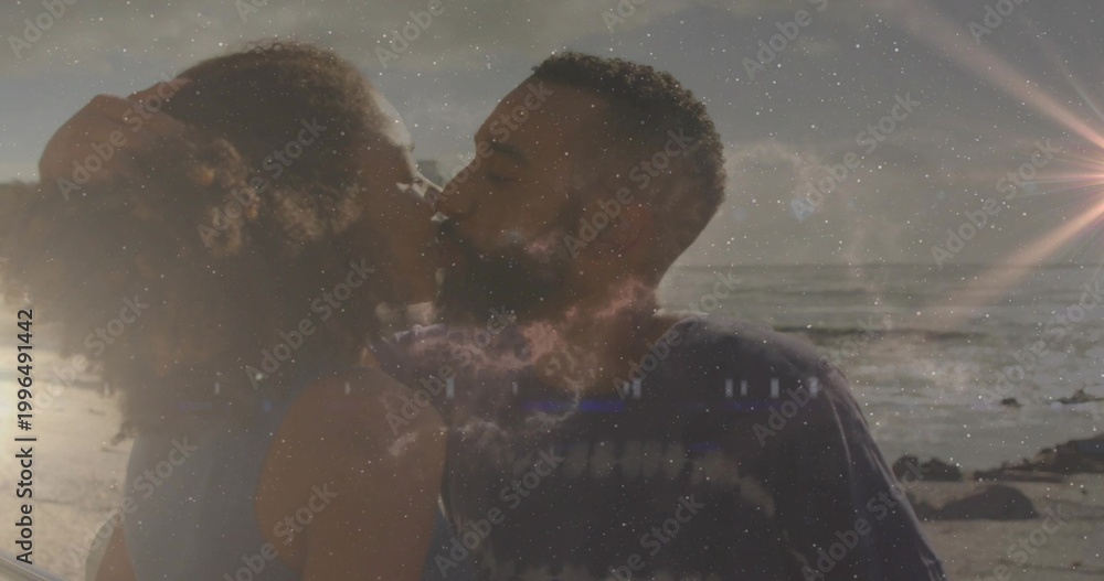 Obraz premium Kissing couple wearing sleeveless top and dark tee, leaning on rocky beach with nebula overlay