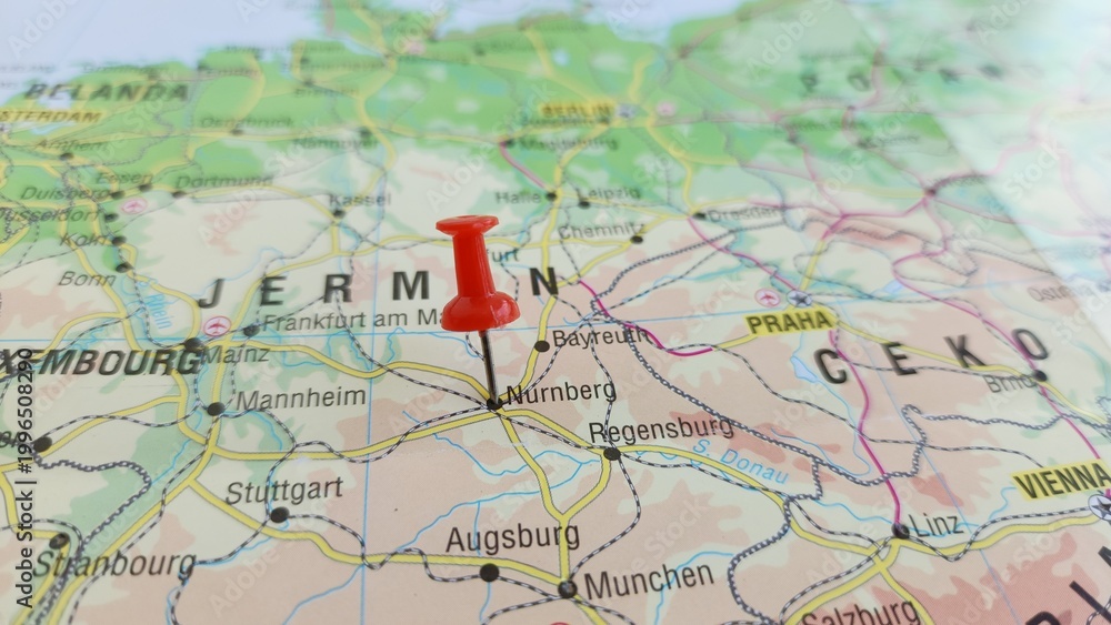 Naklejka premium View of Nuremberg, is the largest city in Franconia and the second-largest city in the German state of Bavaria, on a geographical map of Europe, marked with red push pin