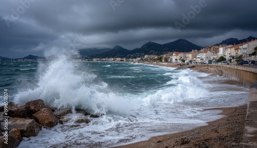 Crashing waves hit rocky shore against a town under stormy skies