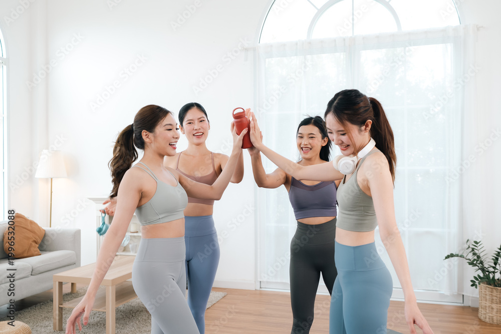Fototapeta premium Wellness pilates and yoga, group exercise fitness women friend workout health training indoor gym team