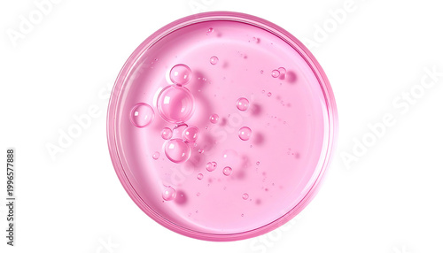 Pink liquid with bubbles in clear dish, against black background