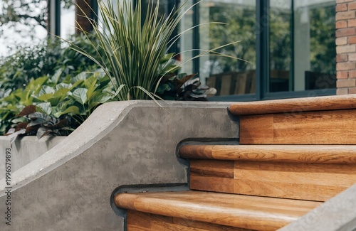 A modern staircase with wooden steps and a concrete railing in a serene outdoor setting
