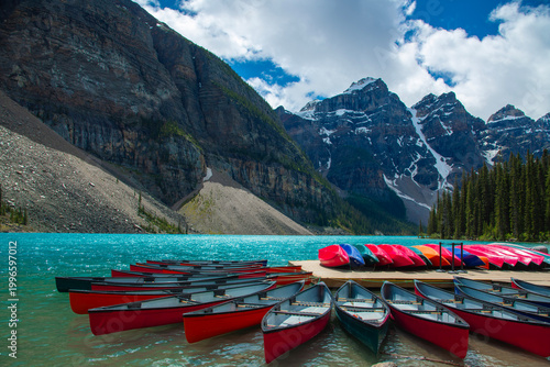 Breathtaking view of Moraine Lake in the Valley of the Ten Peaks, Banff National Park, Alberta, Canada. Vibrant turquoise glacial water surrounded by towering rocky mountains and pine forests