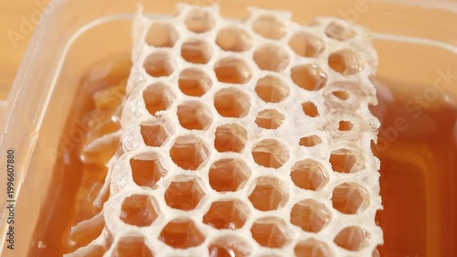 Fresh honey from the forest in a container.