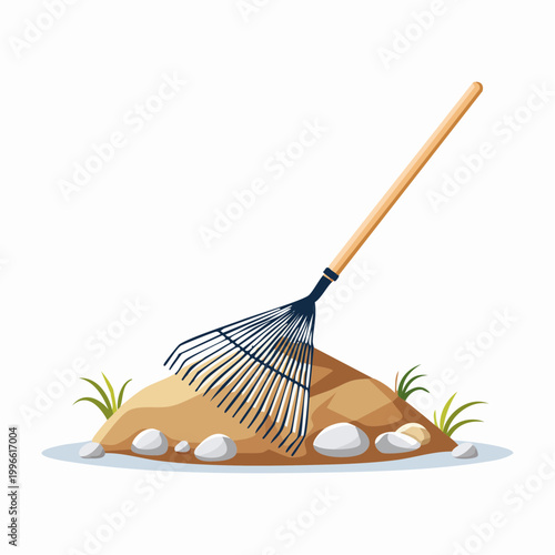 Rake on a pile of dirt with grass and stones
