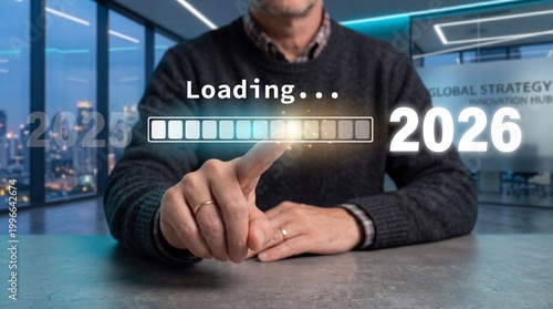 A man in a modern office waiting for a loading screen to finish in 2026