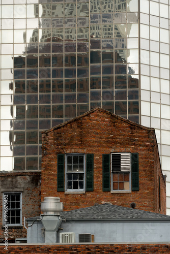 Historic Brick Building Against Reflected Glass Tower New Orleans CBD