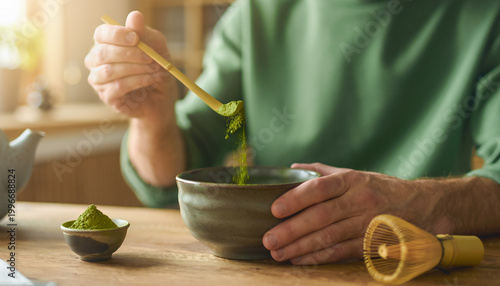 Person Preparing Matcha Tea in Cozy Setting