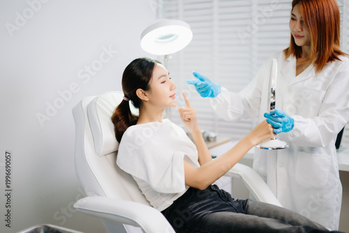 Tableau sur toile Doctor consulting patient in beauty clinic with facial analysis and skincare planning