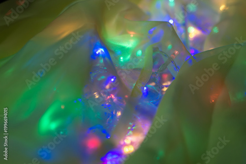 Foto Soft see-through cloth glows with electric rainbow lights like a neon curtain at