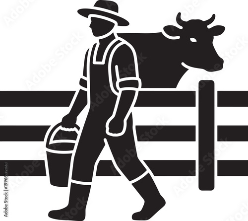 Man in overalls walking with bucket and cow behind fence