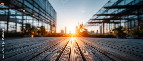 Sunlight hitting wooden deck at sunset in front of modern office building