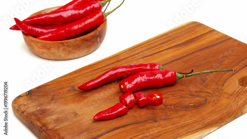 red hot chili pepper on wooden cutting board isolated on white	