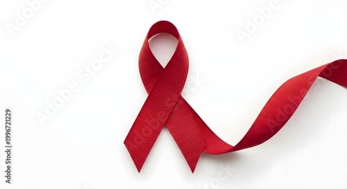 Red ribbon symbol on white background representing awareness and support
