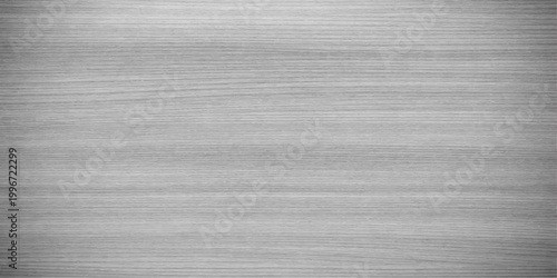 A seamless brushed metal texture background featuring a grey steel pattern and silver aluminum material surface for a blank metallic wallpaper design