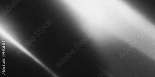 A smooth stainless steel plate with a brushed metallic texture features a shiny silver pattern and a dark gray surface illuminated by a subtle spotlight backdrop design