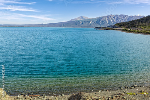Water laps the shore of Lake Kluane near Destruction Bay in the Yukon Territory, Canada