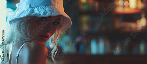 Fashionable woman with a hat at a beach bar