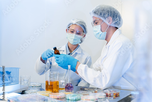 Фотография Two researchers in lab attire collaborate