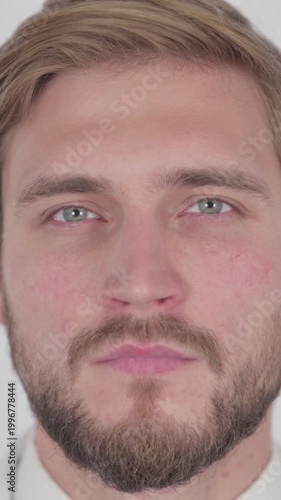 Face of Serious Young Man on White Background, Vertical Video